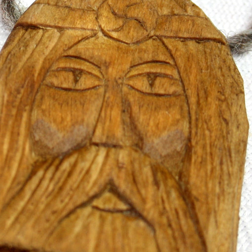 Close-up of handmade Rod wooden amulet with carved details