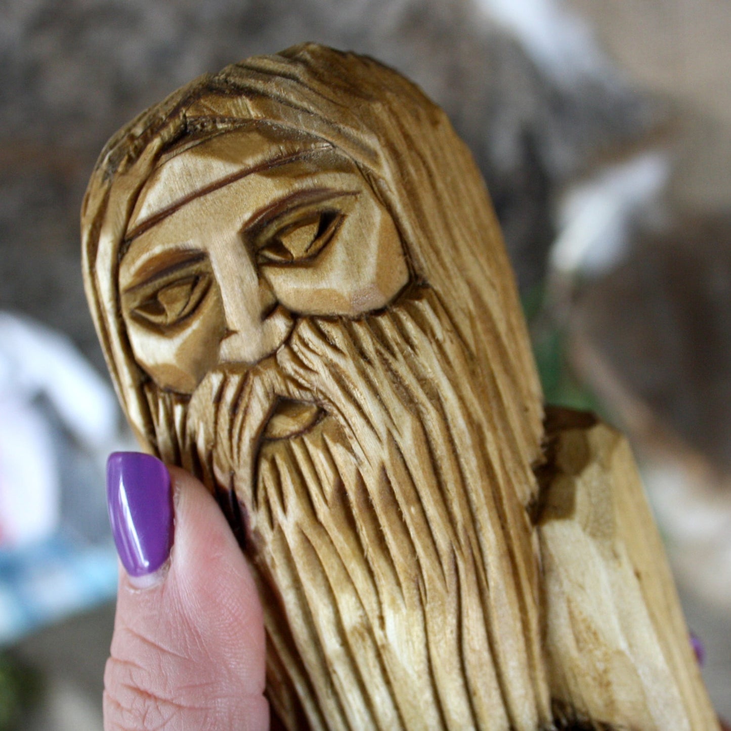 Close-up of Rod Slavic God face hand carved wooden statue