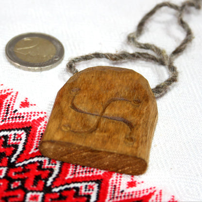 Back side of hand carved Rod pendant made from natural linden wood