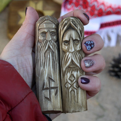Small 10 cm hand-carved Slavic god statue shown in hand