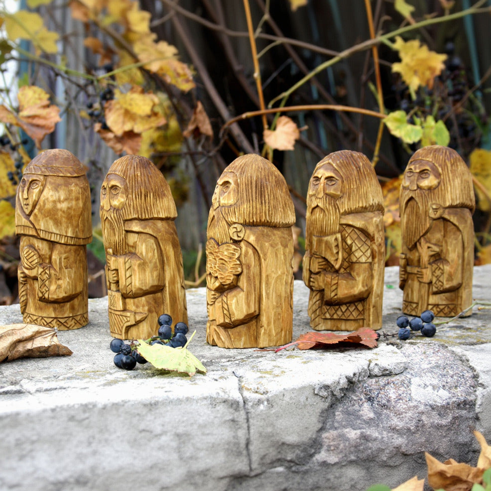 Side view of five hand carved Slavic gods wooden figurines