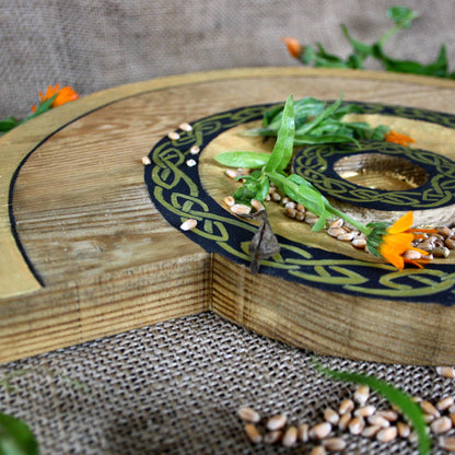 Close-up of handcrafted 35 cm Slavic wooden pagan altar with candle holder