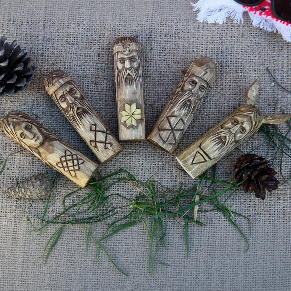 Small Slavic gods wooden idol set 10 cm lying on table front view