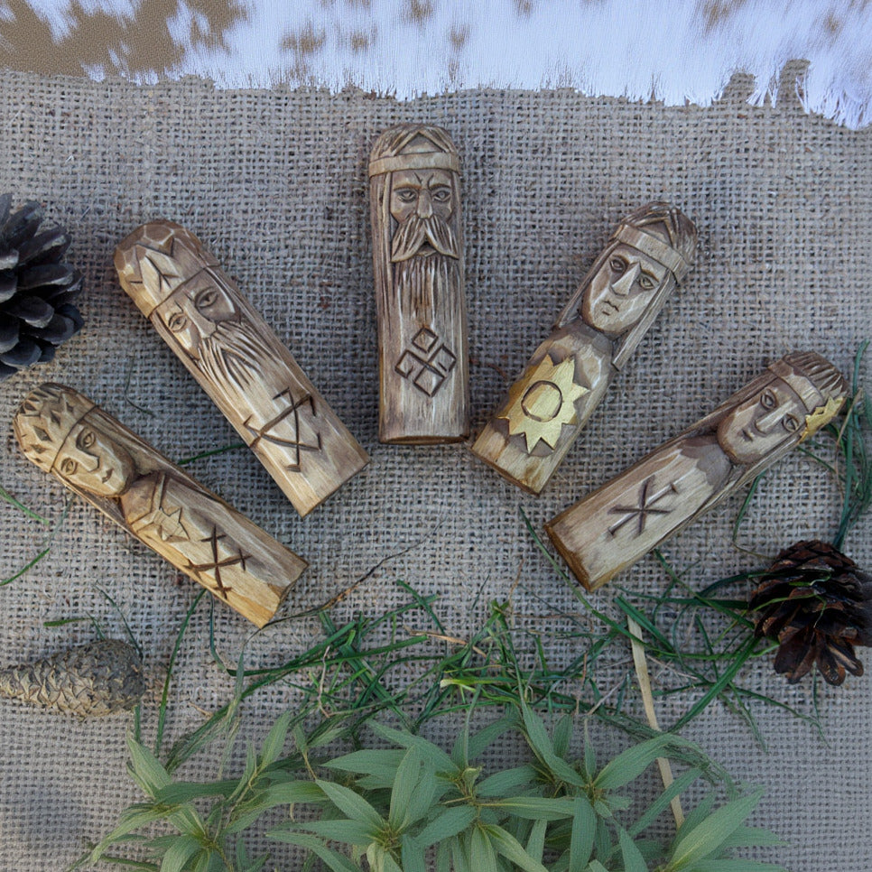 Small Slavic gods wooden idol set 10 cm lying on table top view