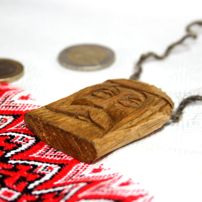 Side view of handmade Svarog wooden pendant