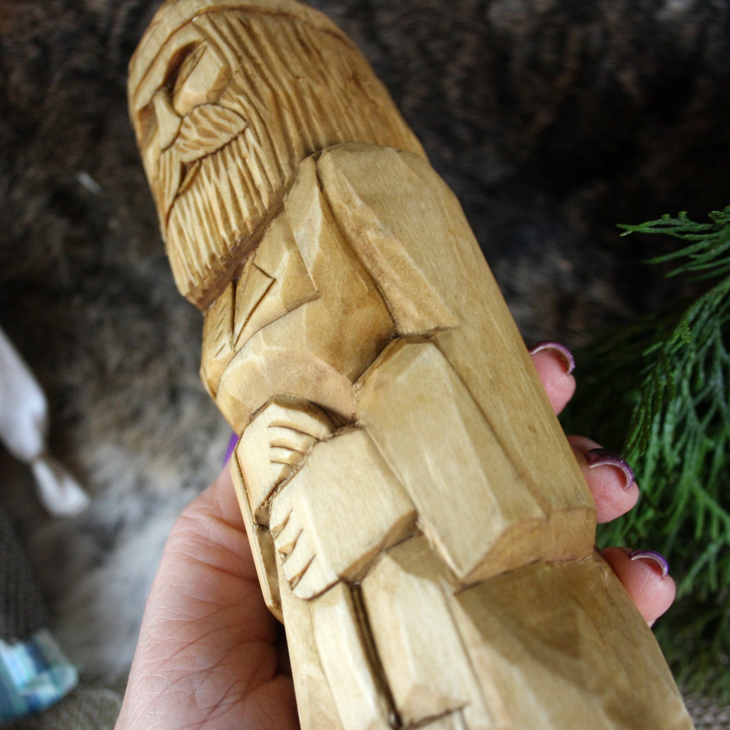 Close-up of Svarog Slavic God face hand carved wooden statue