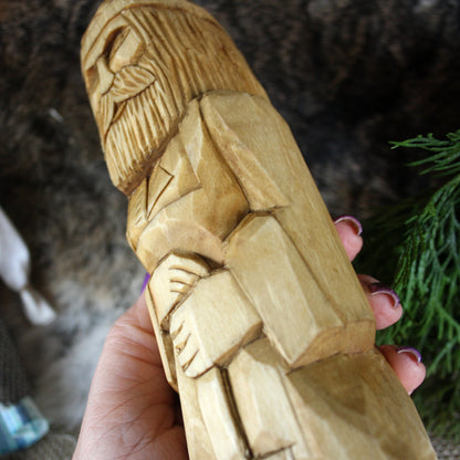 Close-up of Svarog Slavic God face hand carved wooden statue