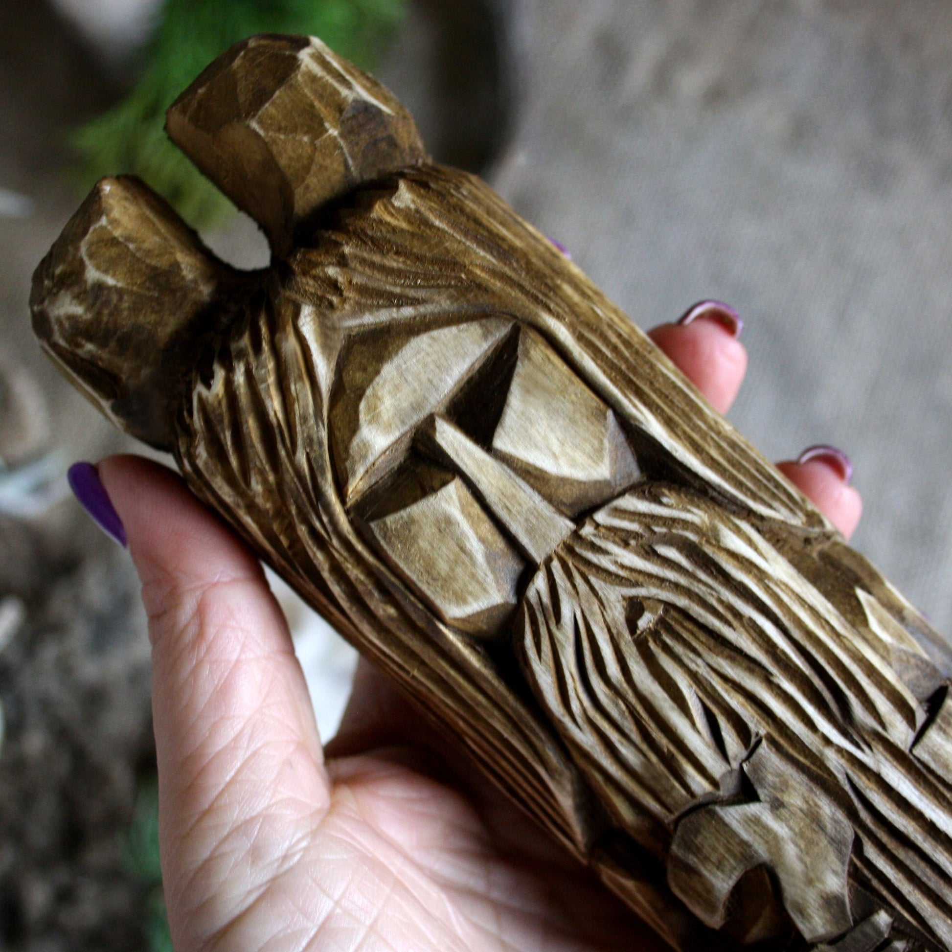 Close-up of Veles Slavic god of wisdom wooden idol 25 cm showing hand-carved facial details