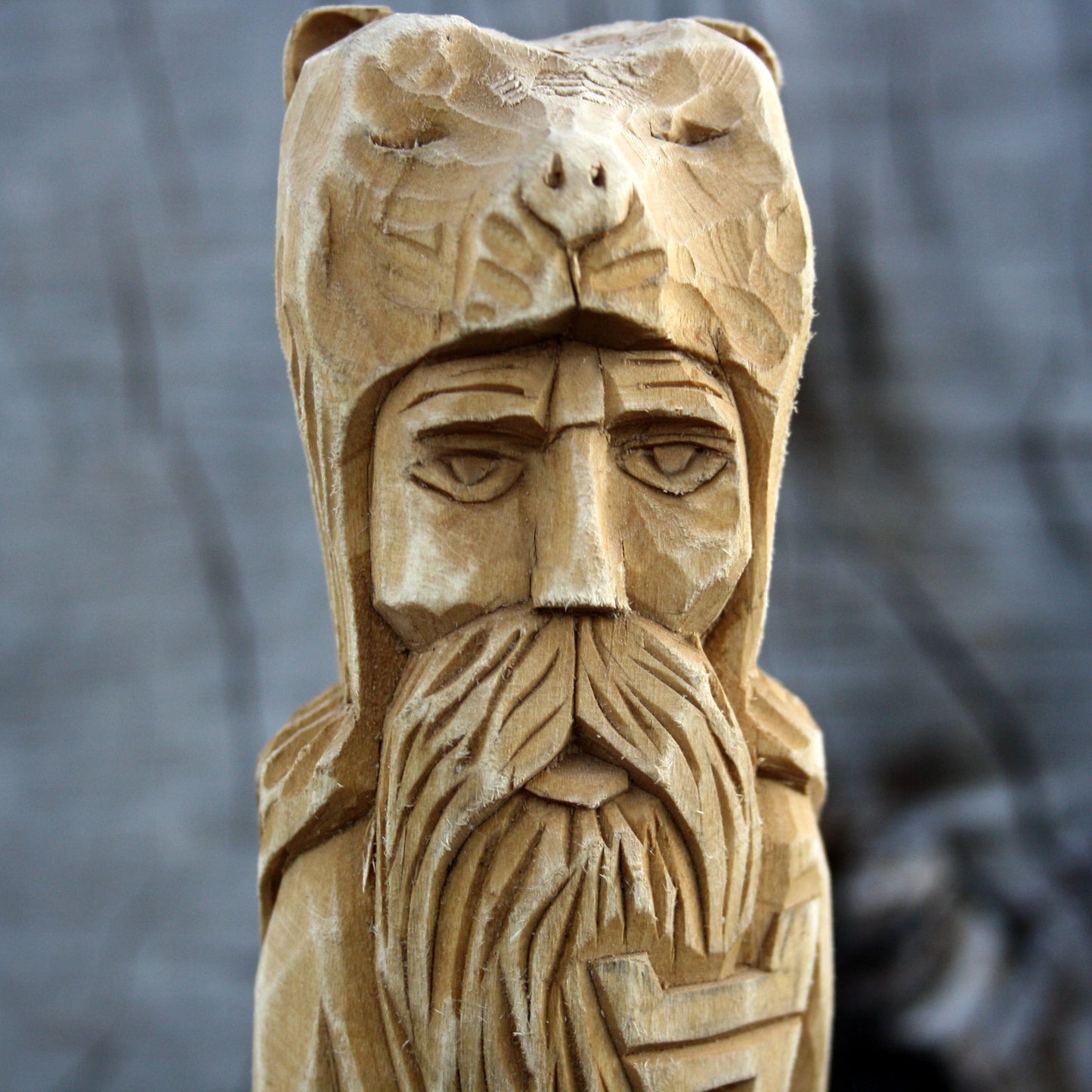 Close-up of Veles Slavic God face hand carved wooden statue