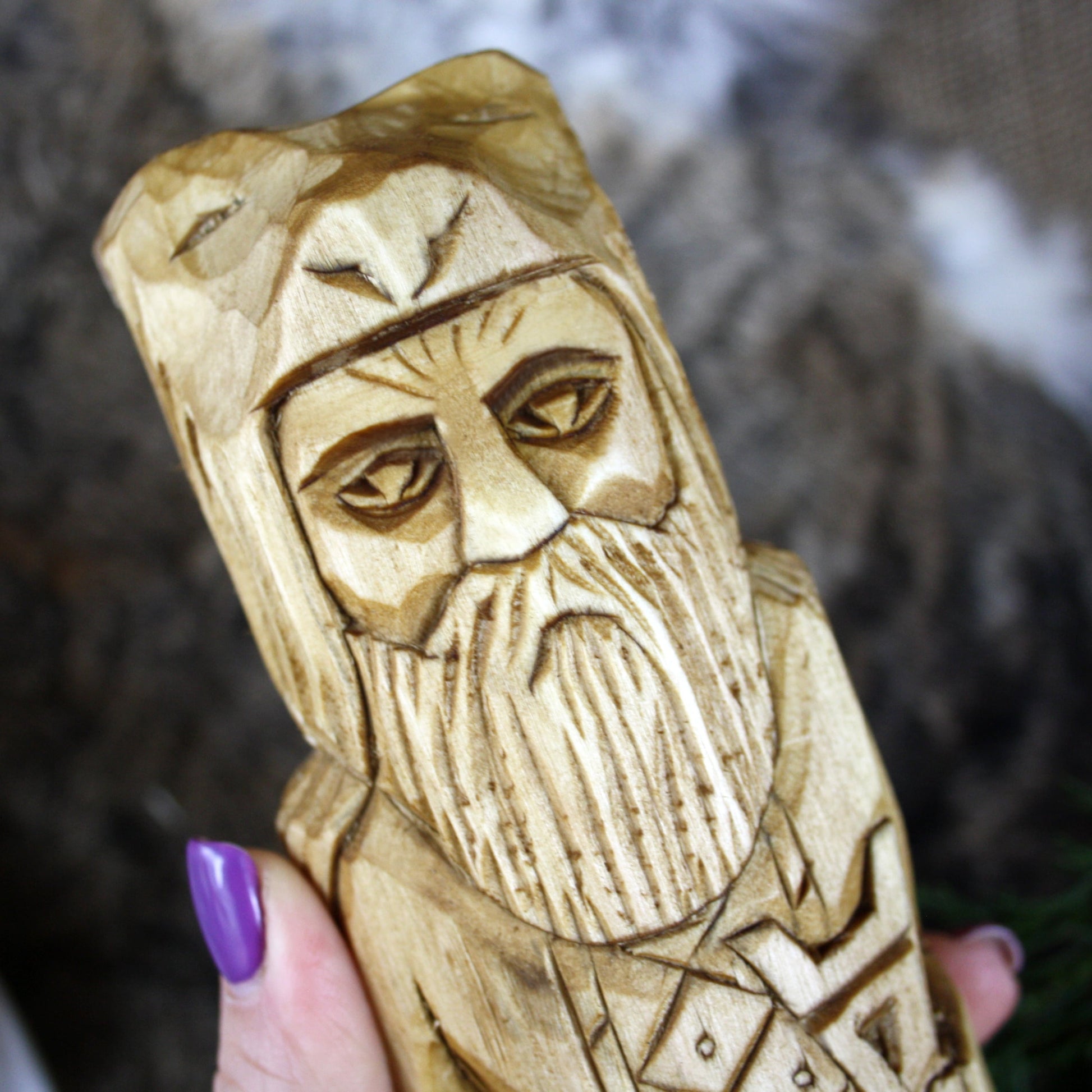 Close-up of Veles Slavic God face hand carved wooden statue