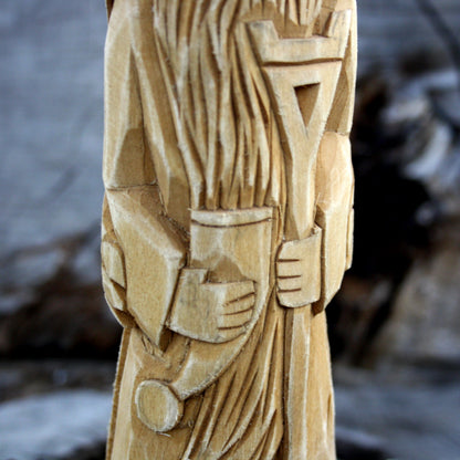 Detailed carving of Veles statue with bear skin cloak