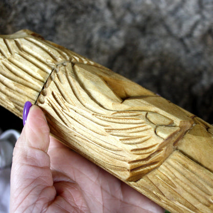 Close-up of natural wood grain on Veles Slavic God statue