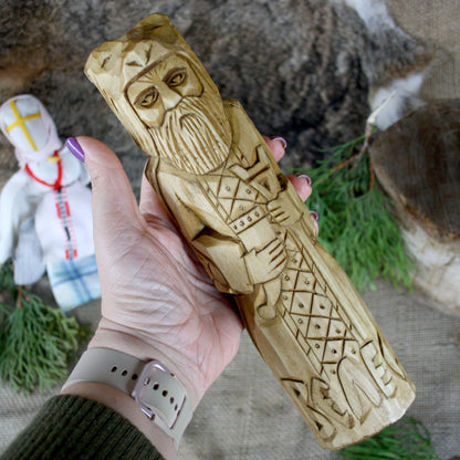 Veles Slavic God wooden statue held in hand for size comparison