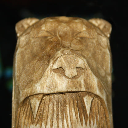 Detailed carving of bear skin on wooden idol