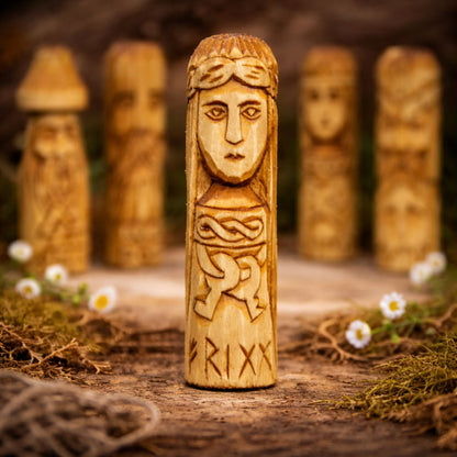 Wooden figurine of Goddess Frigg with engraved design on a natural background