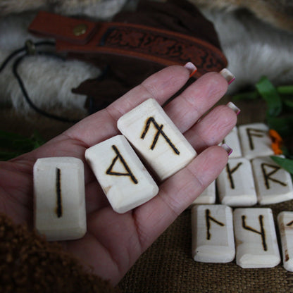 Close-up of handcrafted Slavic runes burned into natural linden wood